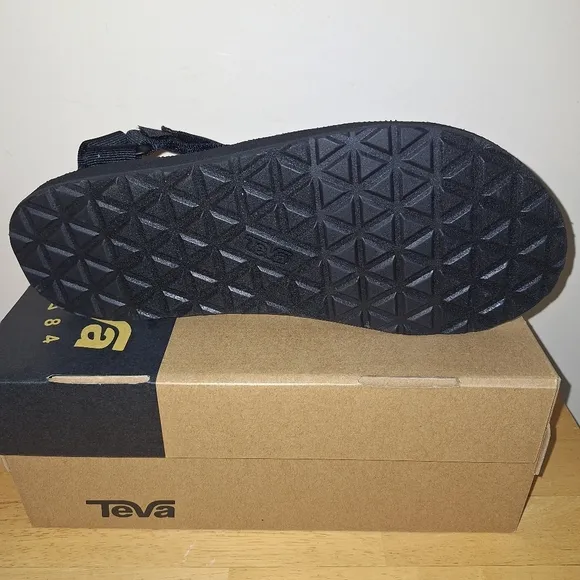 A pair of Teva M. Universal Urban 1004010/BLK. Sandals in a size 9.