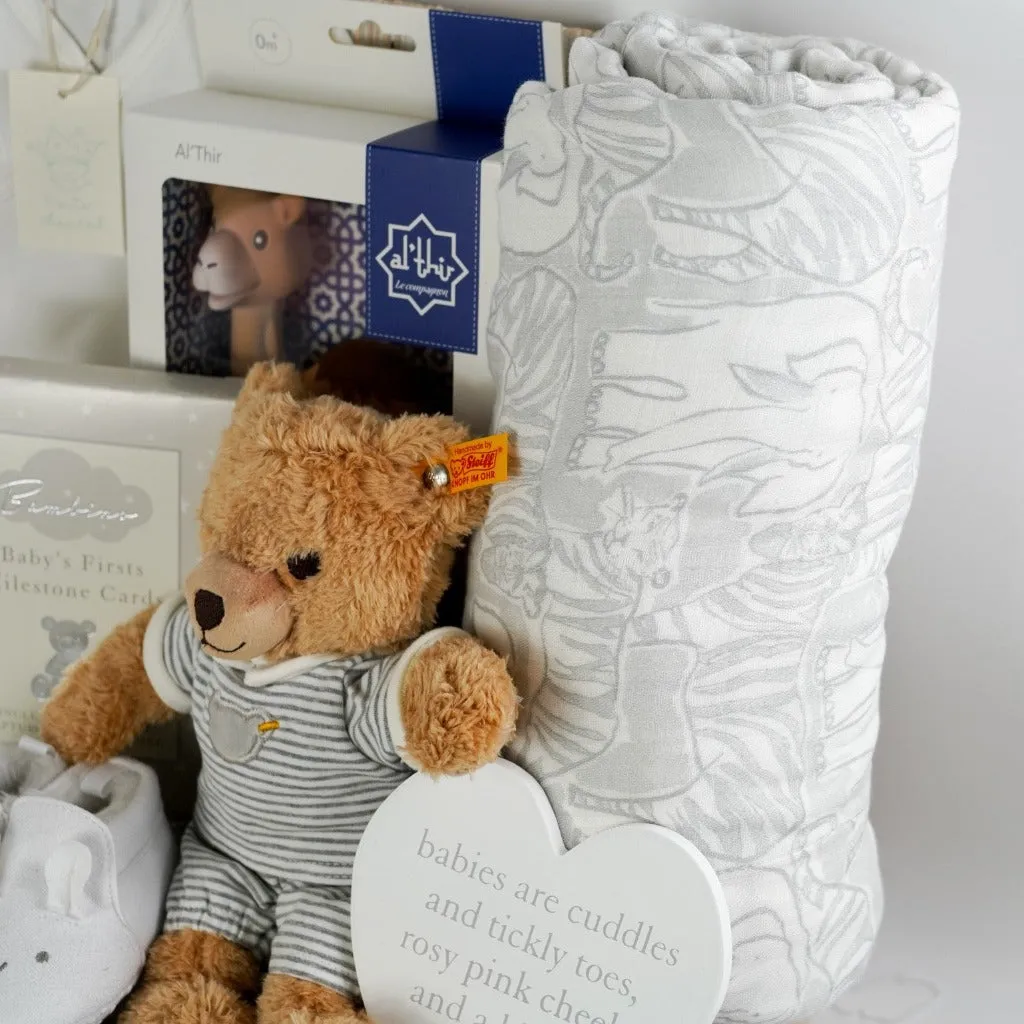 Neutral Baby Gift Hamper Basket, Steiff Teddy Bear, Marie-Chantal Baby Clothing Set, Al'Thir Camel By Sophie Le Giraffe, Aiden And Anais Dream Blanket.